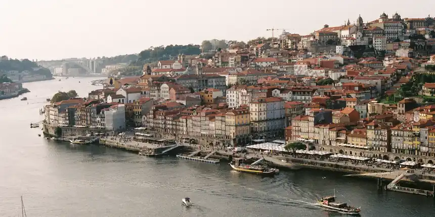 The Douro river curving past the Ribeira waterfront and Vila Nova de Gaia in Porto