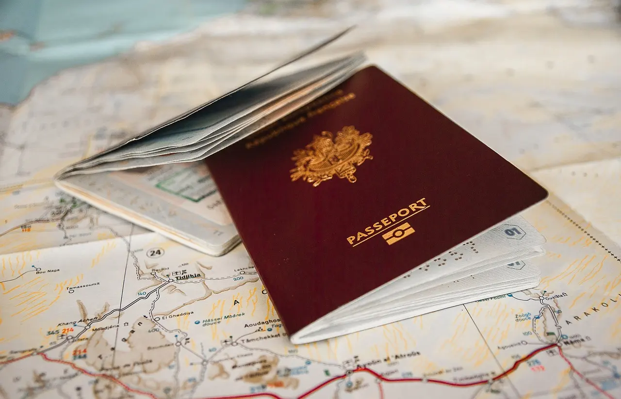 A passport lying open on a folded road map